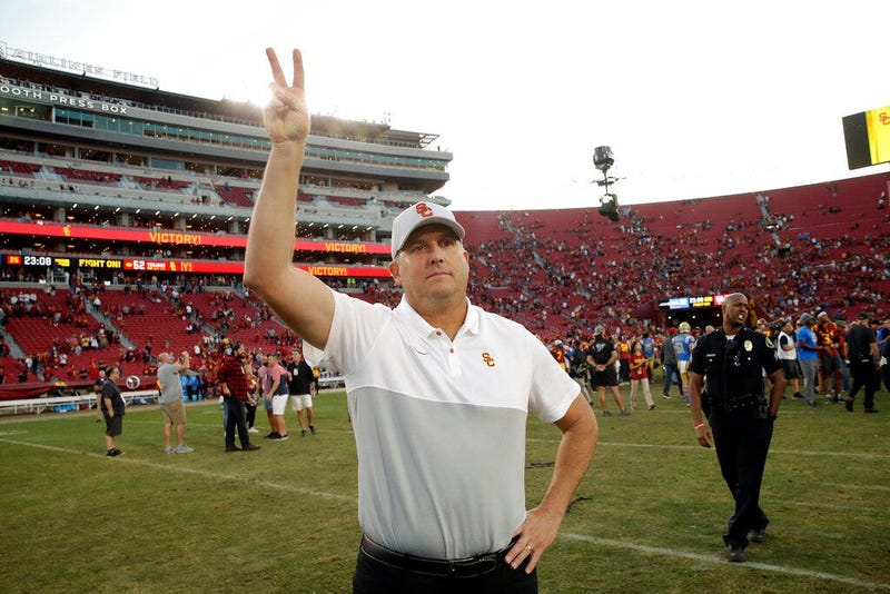 Southern California head coach Clay Helton signals to fans from midfield after a 52-35 win over UCLA in an NCAA college football game, Saturday, Nov. 23, 2019, in Los Angeles.