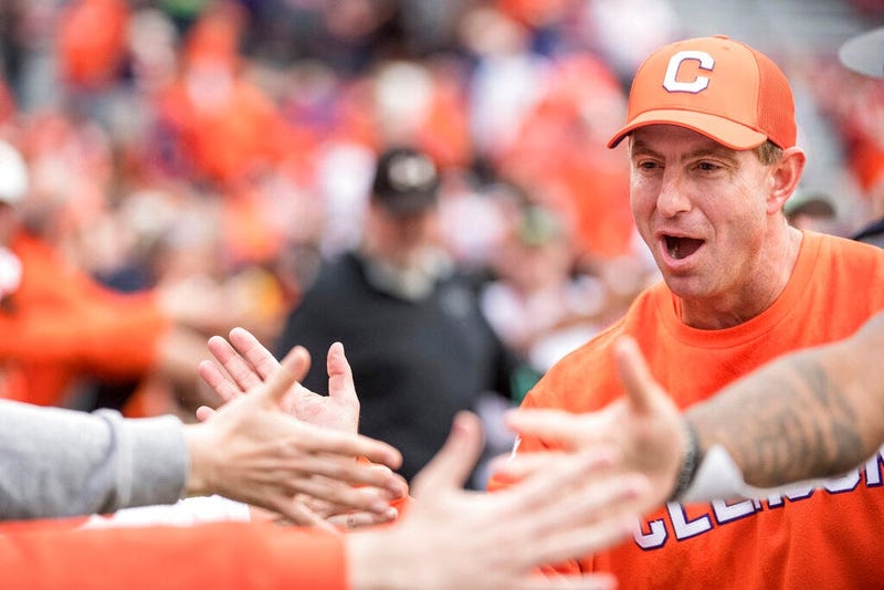 Clemson head coach Dabo Swinney high-fives fans after an NCAA college football game against South Carolina, Saturday, Nov. 30, 2019, in Columbia, S.C. Clemson won 38-3.