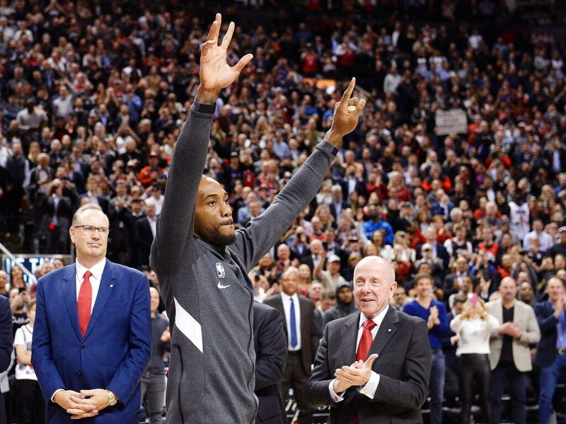Former Toronto Raptors and now Los Angeles Clippers forward Kawhi Leonard salutes the crowd as he receives his 2019 NBA championship ring prior to an NBA basketball game, Wednesday, Dec. 11, 2019, in Toronto.