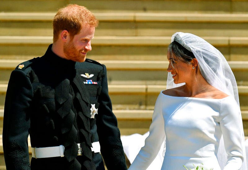Britain's Prince Harry and Meghan Markle walk down the steps after their wedding at St. George's Chapel in Windsor Castle in Windsor, England.