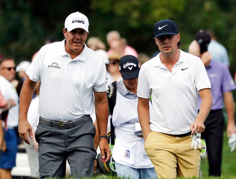 Phil Mickelson, left, talks with Keith Mitchell