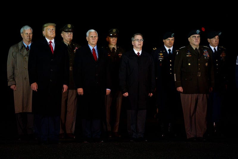 President Donald Trump and Vice President Mike Pence watches as a U.S. Army carry team salutes the transfer case's containing the remains of Sgt. 1st Class Javier Gutierrez, of San Antonio, Texasa and Sgt. 1st Class Antonio Rodriguez