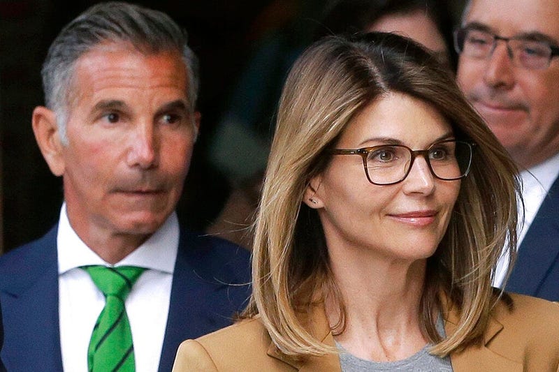 actress Lori Loughlin, front, and husband, clothing designer Mossimo Giannulli, left, depart federal court in Boston after facing charges in a nationwide college admissions bribery scandal. The famous couple pleaded guilty to charges in May 2020, and are