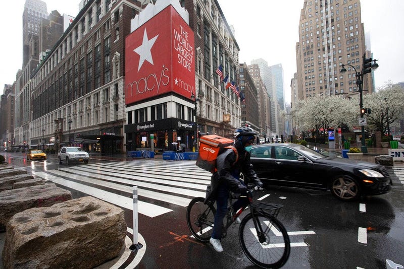 A cyclist passes Macy's in Herald Square, Monday, March 23, 2020, in New York. Macy's stores nationwide are closed due to the coronavirus.