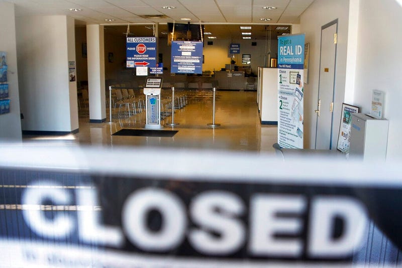 the seats and aisles are empty as seen through the window of the closed Penndot Drivers License Center in Butler, Pa.