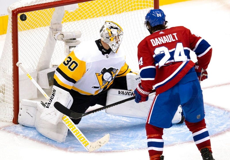 Montreal Canadiens centre Phillip Danault (24) watches as the puck bounces off the post behind Pittsburgh Penguins goaltender Matt Murray (30) during the third period of an NHL hockey playoff game Wednesday, Aug. 5, 2020 in Toronto