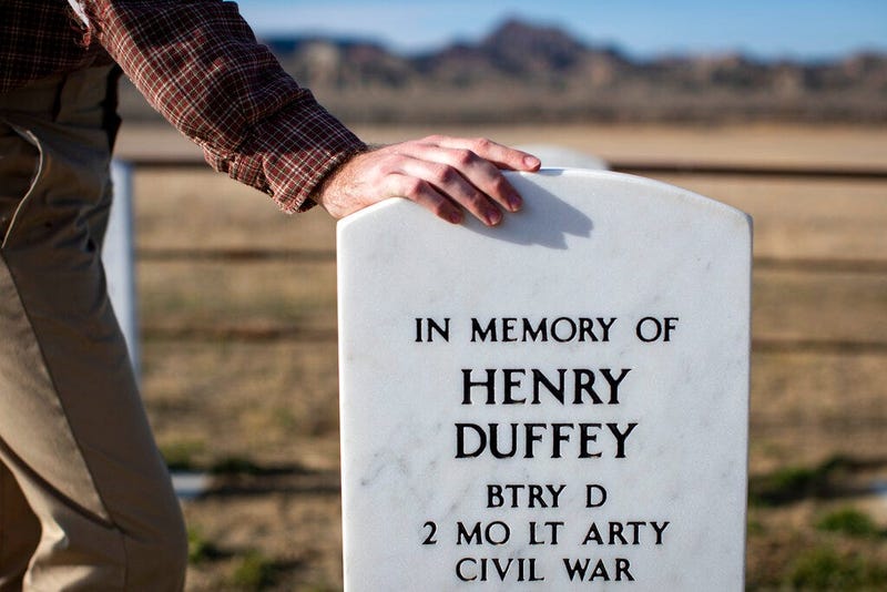 Jaeger Held poses for a portrait next to the memorial markers for members of the Powder River Expedition of 1865 near Broadus, Mont. on Wednesday, Nov. 4, 2020.