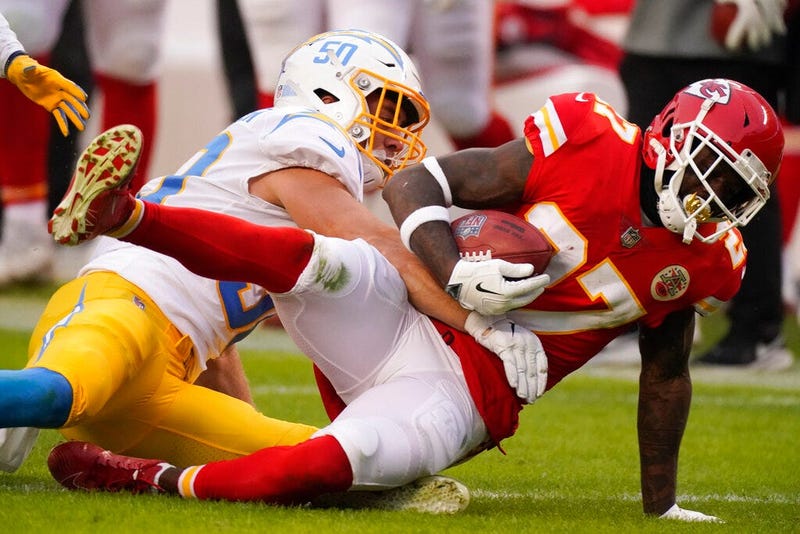 Kansas City Chiefs' Rashad Fenton is tackled by Los Angeles Chargers linebacker Cole Christiansen, left, during the first half of an NFL football game, Sunday, Jan. 3, 2021, in Kansas City.