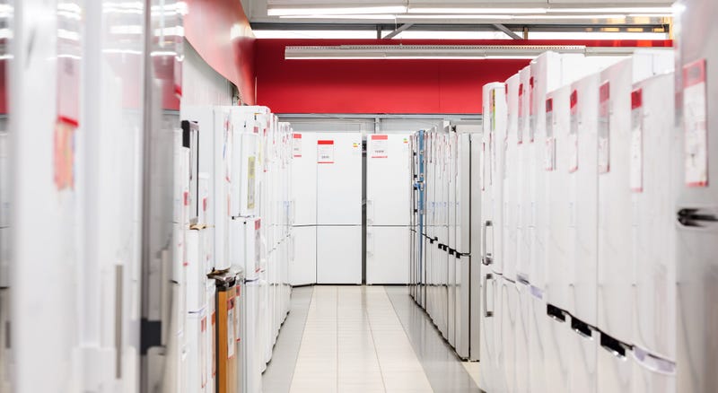 rows of refrigerators in appliance store