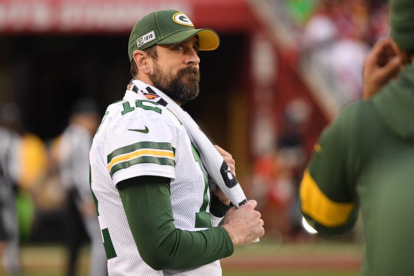 Aaron Rodgers looks on from the Packers sideline.