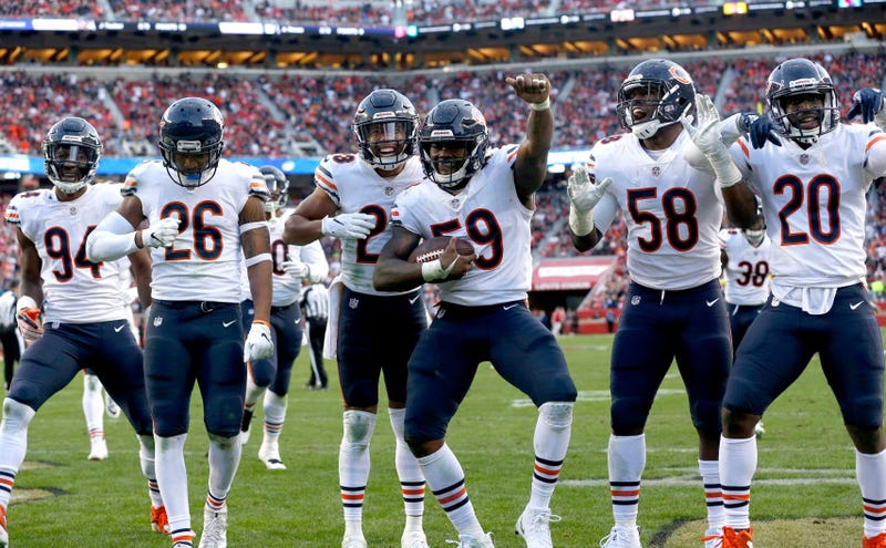 Bears linebacker Danny Trevathan (59) celebrates with teammates after recording an interception.