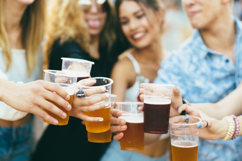 Friends drinking beer and having fun at festival
