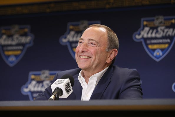 NHL Commissioner Gary Bettman laughs during a press conference.