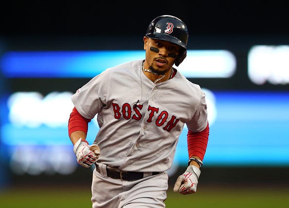 Mookie Betts rounds the bases after hitting a home run.