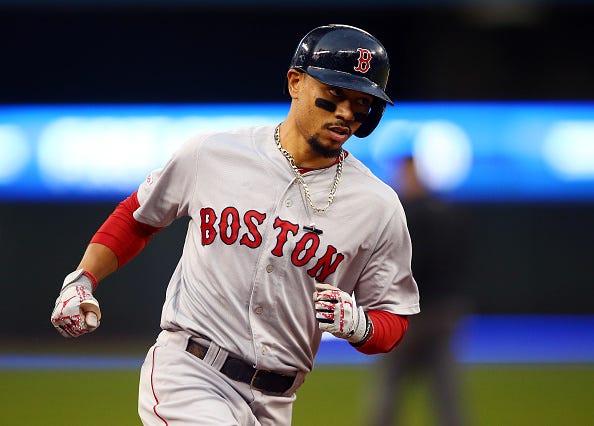 Red Sox Mookie Betts rounds the bases after homering against the Blue Jays.