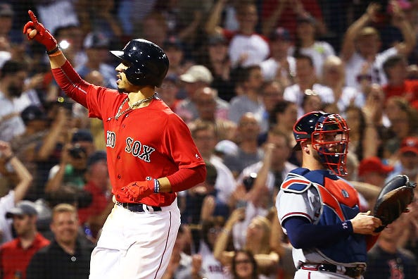 Mookie Betts celebrates scoring a run against the Atlanta Braves.