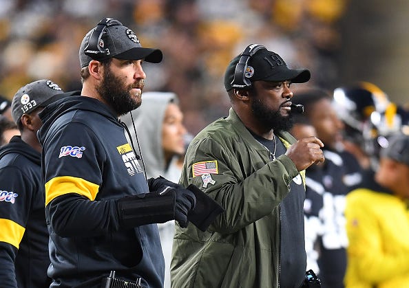 Ben Roethlisberger and Mike Tomlin watch from the Steelers sideline.