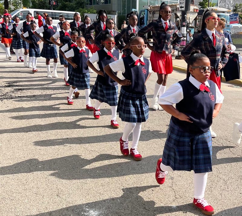 Dozens of people march on South King Drive in the Bud Billiken Parade