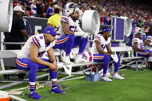 Bills players watch in disappointment as they fall to the Texans.