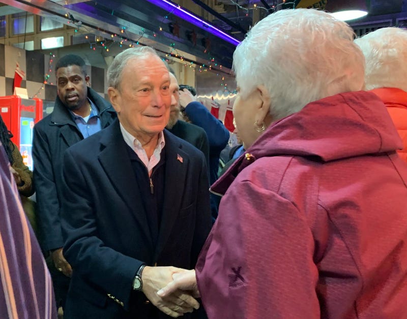 Former New York mayor turned Democratic presidential candidate Michael Bloomberg greets a woman at Reading Terminal Market.