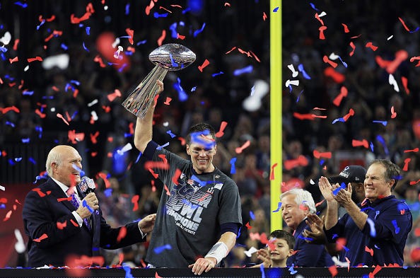 Tom Brady hoists the Lombardi Trophy after winning the Super Bowl.