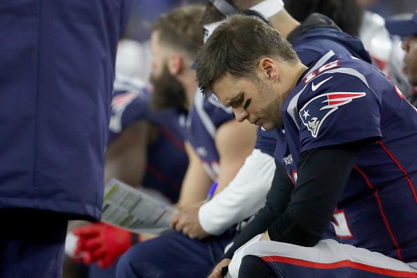 Tom Brady sits on the bench during the Patriots' 2019 Wild Card game.