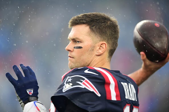 Tom Brady warms up on the Patriots' sideline