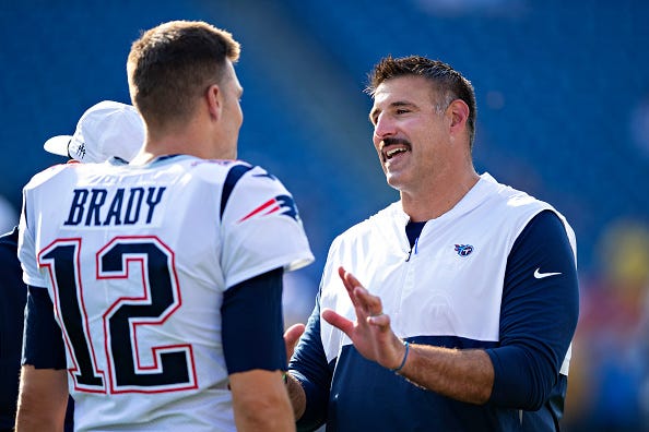 Tom Brady chats with Titans head coach Mike Vrabel
