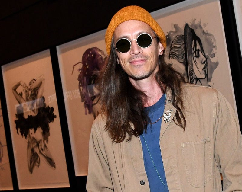 Brandon Boyd of Incubus poses in front of his artwork.