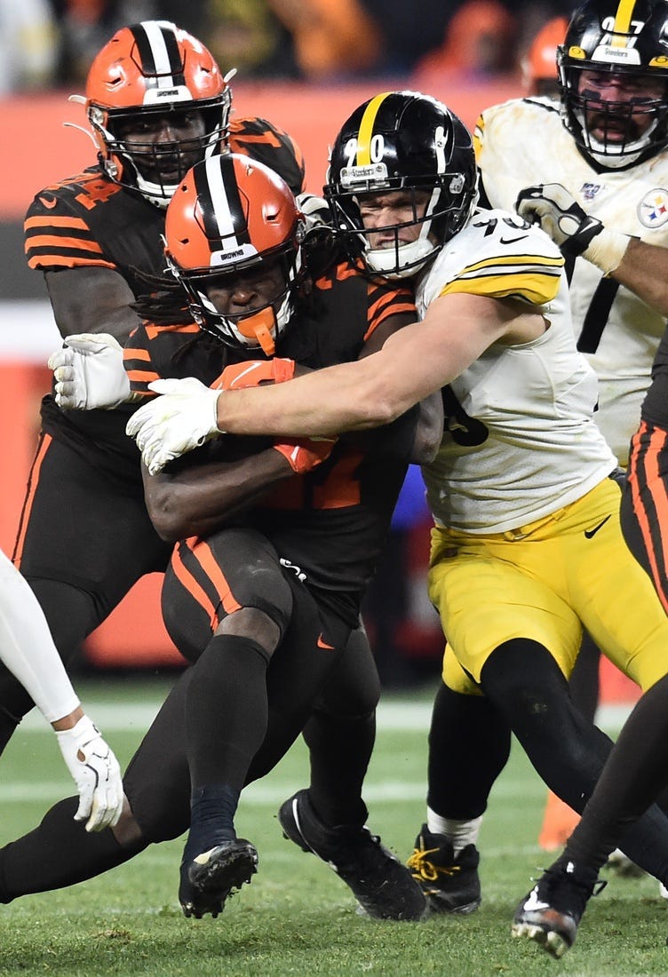 Nov 14, 2019; Cleveland, OH, USA; Pittsburgh Steelers outside linebacker T.J. Watt (90) tackles Cleveland Browns running back Kareem Hunt (27) during the second half at FirstEnergy Stadium.