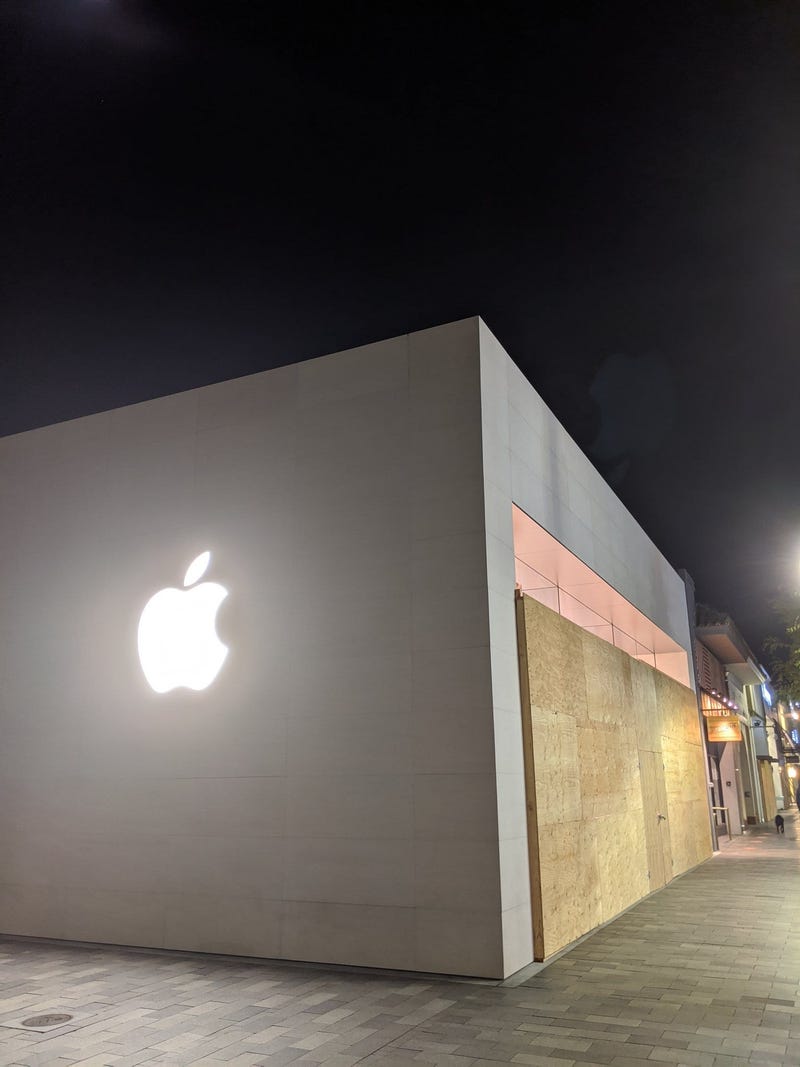One of several stores boarded up with plywood in downtown Burlingame.