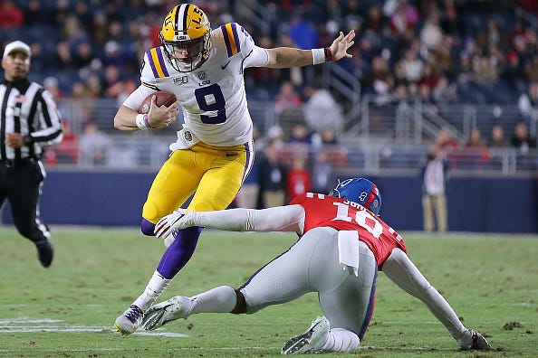 LSU QB Joe Burrow avoids a tackle against Ole Miss