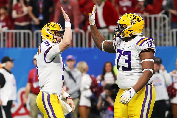 LSU QB Joe Burrow high-fives teammate Adrian Magee in the Peach Bowl.