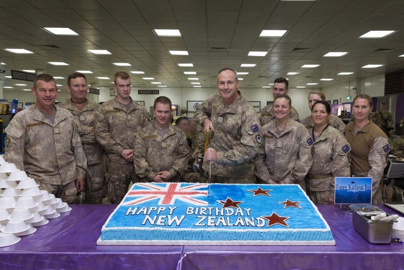 Lt. Col. Darren Beck, New Zealand Army, cuts the Waitangi Day cake in the dining facility at Camp Taji, Iraq, Feb. 6, 2019.