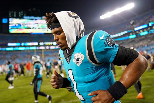 Carolina Panthers QB Cam Newton jogs off the field.