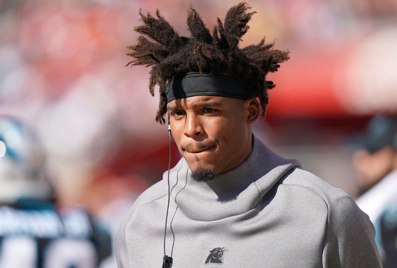 Cam Newton walks the field before a Panthers game.