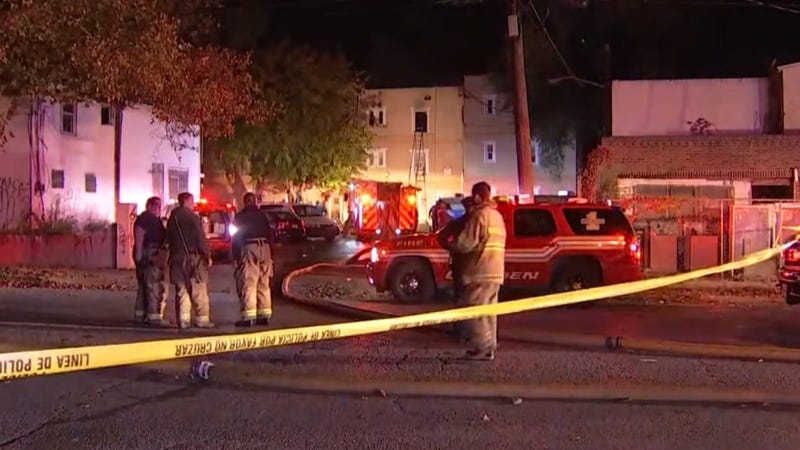 At least two people were killed and more than a half-dozen injured, including one firefighter, following a three-alarm fire at a Camden apartment building.