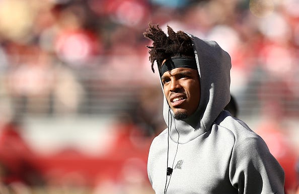 Cam Newton watches warmups before a Panthers game.