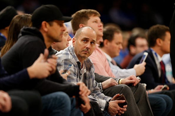 Yankees GM Brian Cashman takes in a basketball game.