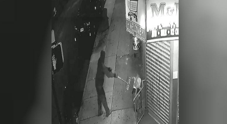 Screencap of surveillance video of a man who disposed of the dead cat after finding it outside a corner store.
