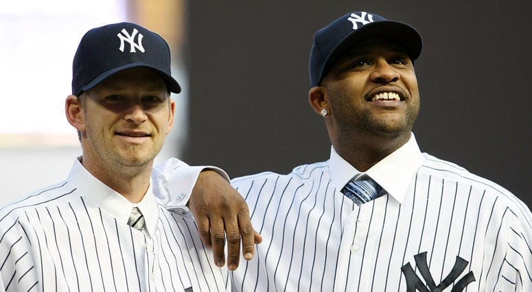 CC Sabathia and A.J. Burnett pose for photographers after a press conference announcing their signings with the Yankees on Dec. 18, 2008.