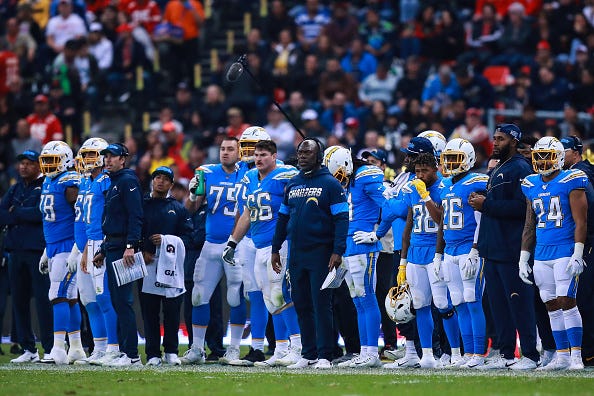 Anthony Lynn stands alongside his team on the Chargers sideline.