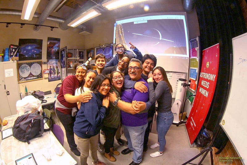 Class of students with astronomy teacher