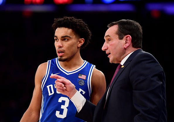 Duke's Tre Jones chats with Mike Krzyzewski between plays.