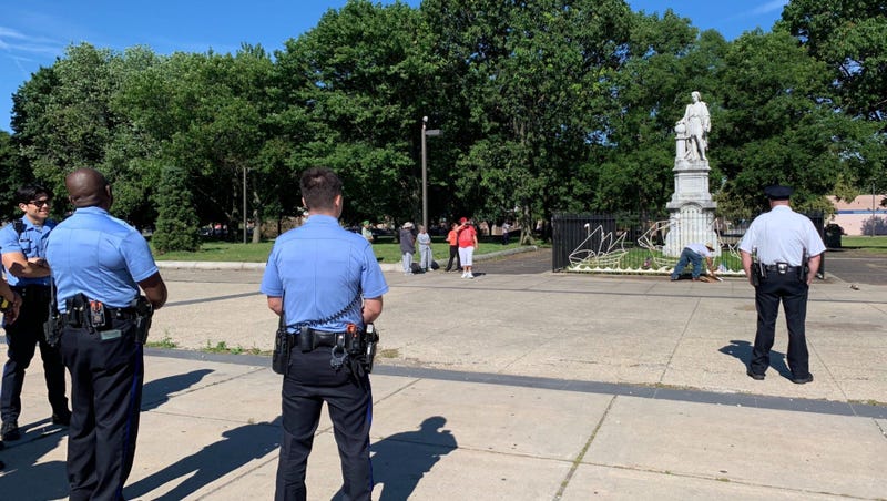 Philadelphia police stand guard in Marconi Plaza Sunday morning following reports of armed vigilantes around the Christopher Columbus statue.