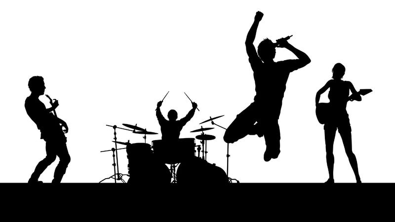 Band on stage in silhouette
