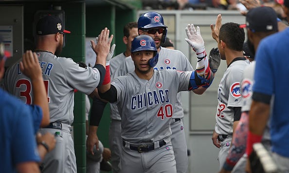 Cubs teammates congratulate Willson Contreras in the dugout.