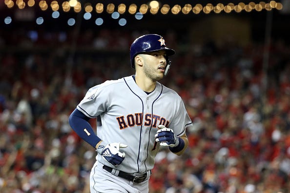 Carlos Correa looks on after hitting a home run in the World Series.