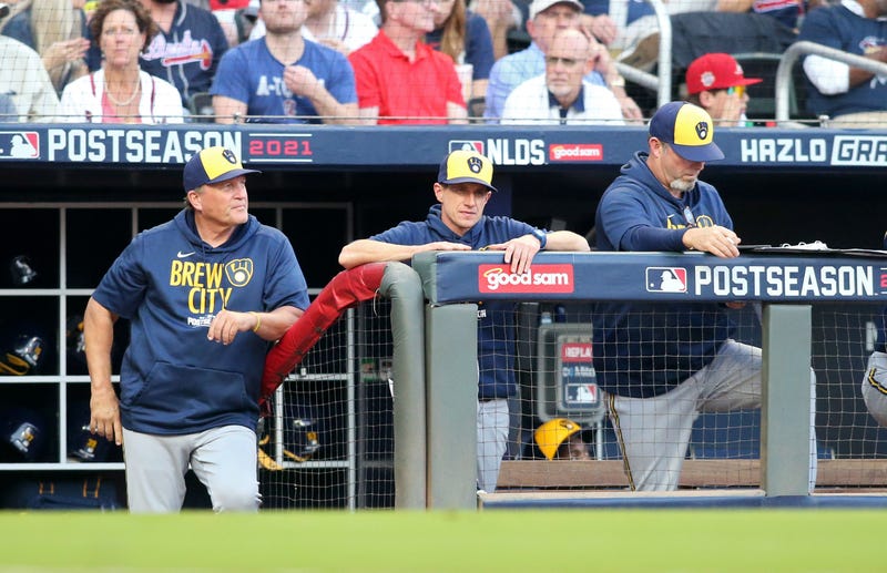 Oct 12, 2021; Cumberland, Georgia, USA; Milwaukee Brewers manager Craig Counsell (center) looks on from the dugout during the third inning against the Atlanta Braves in game four of the 2021 ALDS at Truist Park. Mandatory Credit: Brett Davis-USA TODAY Sports