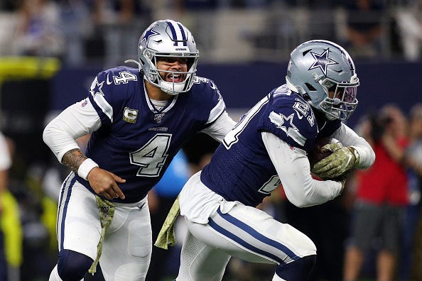 Dak Prescott hands the ball off to Ezekiel Elliott